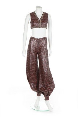 An early Thea Porter harem ensemble, 1968, labelled: An early Thea Porter harem ensemble, 1968, labelled 'Thea Porter, London', the cropped bolero bodice edged in pearl and clear beads, the silver and red fabric with small paisley repeats, bust 81cm, 32