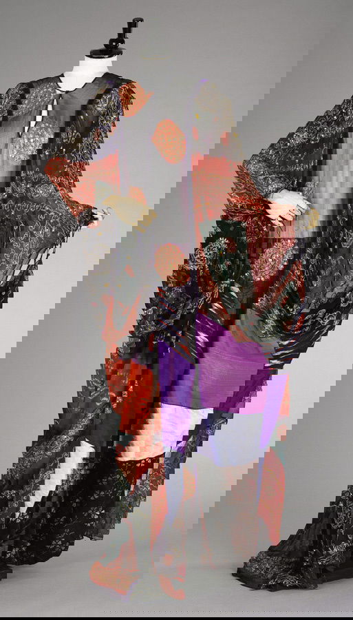 An exotic Thea Porter kaftan, English, circa 1970,: An exotic Thea Porter kaftan, English, circa 1970, bearing Couture label, composed of a patchwork of Indian embroidered chiffon, ikat, batik and slubbed silk bands, the loose flowing gown has no bust