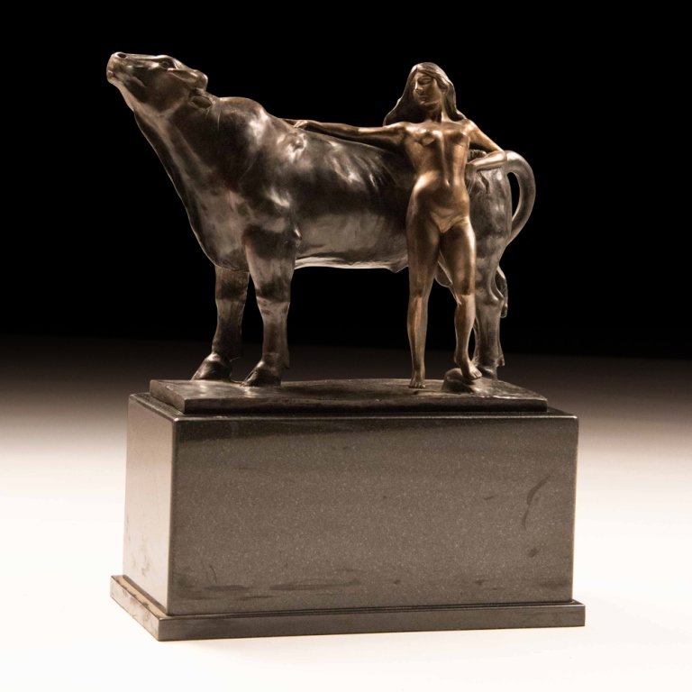 A Bronze and Marble Statue: This is a bronze state of a girl resting against a cow set upon a marble base. Measures 20.75 x 19 x 8 inches
