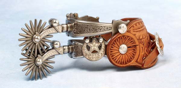 Ernie Marsh (TCA) Elko Star Spurs: Maker-marked E Marsh / 164 / 1999 inside both heelbands, full mounted spurs are patterned after the renowned G S Garcia pattern. A dazzling combination of inlaid engraved sterling silver with Moorish