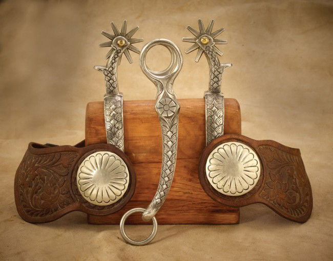 Bill Heisman TCA Star Steel Silver Bit and Spur Se: Traditional Cowboy Artist (TCA) founding member and past president Bill Hesiman of Tucson, AZ took an unmounted Buermann Star Steel Silver bit and spur set in 2007 and engraved both in a wheat shaft p