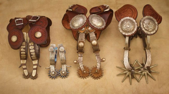 Four (4) Pairs of Miscellaneous Spurs: a) Buermann Cat Pat #1250 iron spurs post-factory silver overlay with 3 1/2", 10 pt solid nickel rowels, 2-piece floral straps adorned with 2 1/2" silver let 'er buck conchos; b) Shop-made silver spur