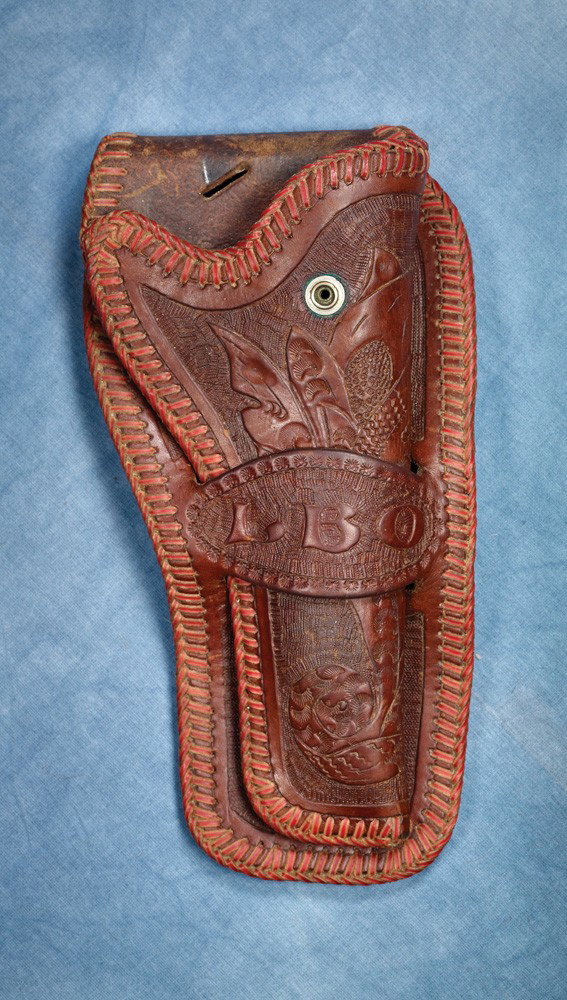 Luis B Ortega’s Personal Holster: From the private collection of Luis B Ortega comes a floral carved leather holster made for a 7 1/2” Colt SAA. The loop features Luis’s LBO initials and the back of has LUIS B ORTEGA and O-P (Orte