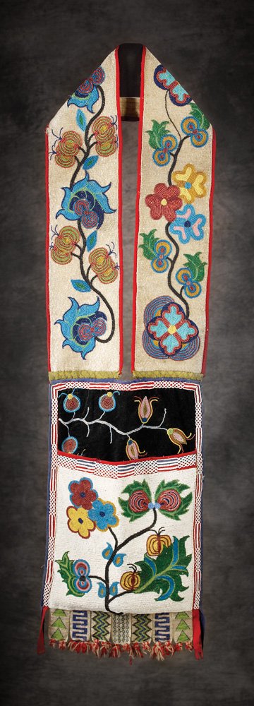 Ojibwa Beaded Bandolier Bag: 39" x 12" Multi-colored floral designs on cloth with looped bugle beads on fringe. Good condition with some bead and fringe loss, c 1900