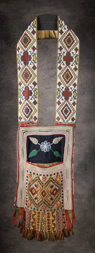 Woodlands Beaded Bandolier Bag: 41" x 11" multicolored geometric loomed beadwork designs on trade cloth with tabs and yarn tassels. Good condition with minor bead loss, c 1880