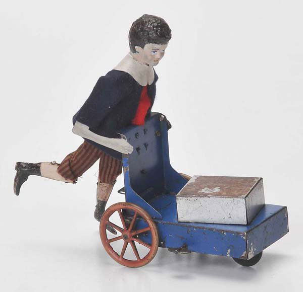 Martin: Martin, Boy with Baggage, France, 19cm, tin, friction ok, paint damage, head and arms replaced Deutsche Beschreibung: Martin, Junge mit Gepäck, Frankreich, 19cm, Blech, Friktion ok, Lackmängel, Kopf