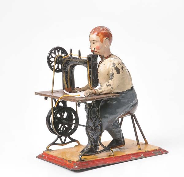 Carette: Carette, Tailer with Sewing Machine, Germany prewar, tin, paint damage, driven by steam engine, good condition, Deutsche Beschreibung: Carette, Schneider mit Nähmaschine, Germany VK, H 15 cm, Blech, 