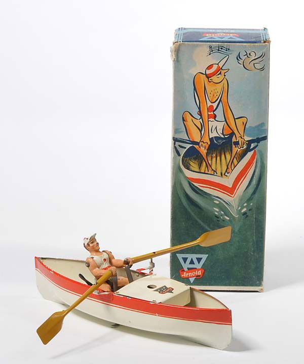 Arnold: English: Arnold, Boat with Rower, US Zone Germany, tin, windup gets stuck, damage to paint on edging, original box condition 1-2, painting of figure is flaking off, otherwise good condition 1-2 Deutsc