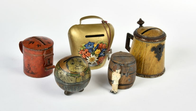 Spardosen: 5 Spardosen, 1x Marklin, rot, um 1870, 1x Bierkrug figurlich, handlackiert, 1872, 1x Fassform figurlich mit Madchenfigur, Zinkguss, handlackiert (Heyde?), 1x Kugelform, "Frau mit Schurze", 3 Kugelfuss