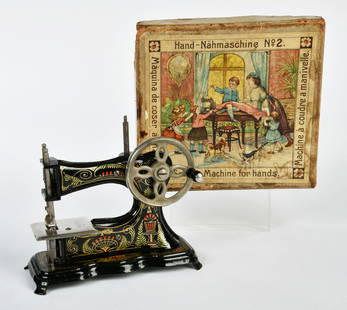 Muller, Kindernahmaschine: Muller, children's sewing machine, "Hand Sewing Machine No. 2", cast iron, painted black, drive wheel hinged on the side, original box, stamped on the side 29.11.04