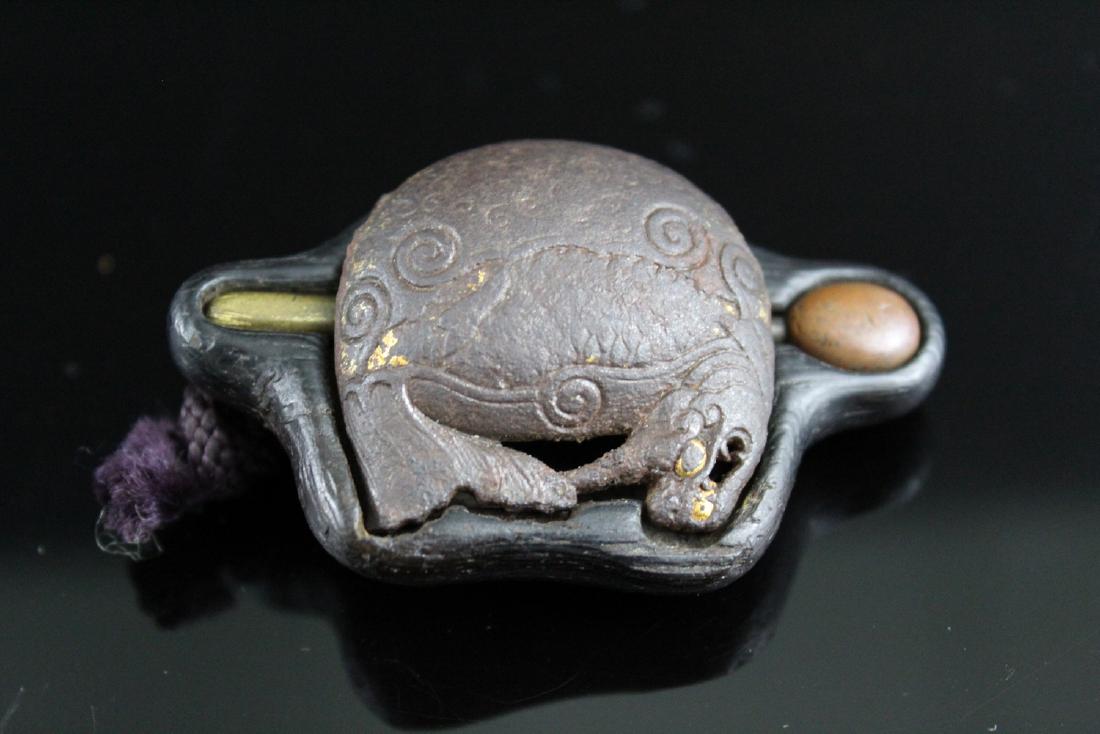 Japanese gilted metal Buddhist mokugyo with a dark wood: Japanese gilted metal Buddhist mokugyo with a dark wood base, 19th Century. Length 6.5 cm.