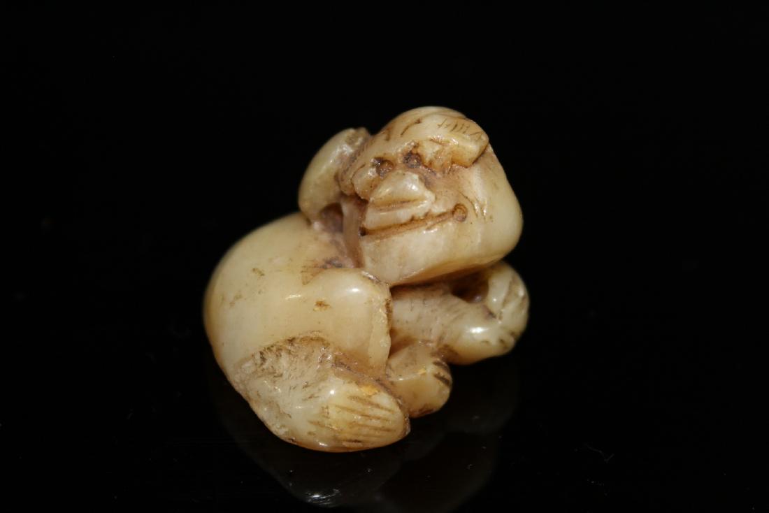 Japanese carved jade netsuke of a dog.: Japanese carved jade netsuke of a dog. Length 3.3 cm.