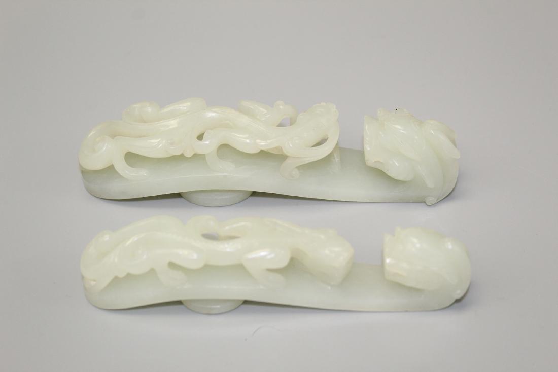Two large Chinese white jade belt buckles.: Two large Chinese white jade belt buckles. 13.5 and 12.5 cm long. Provenance: A San Antonio, TX collector.