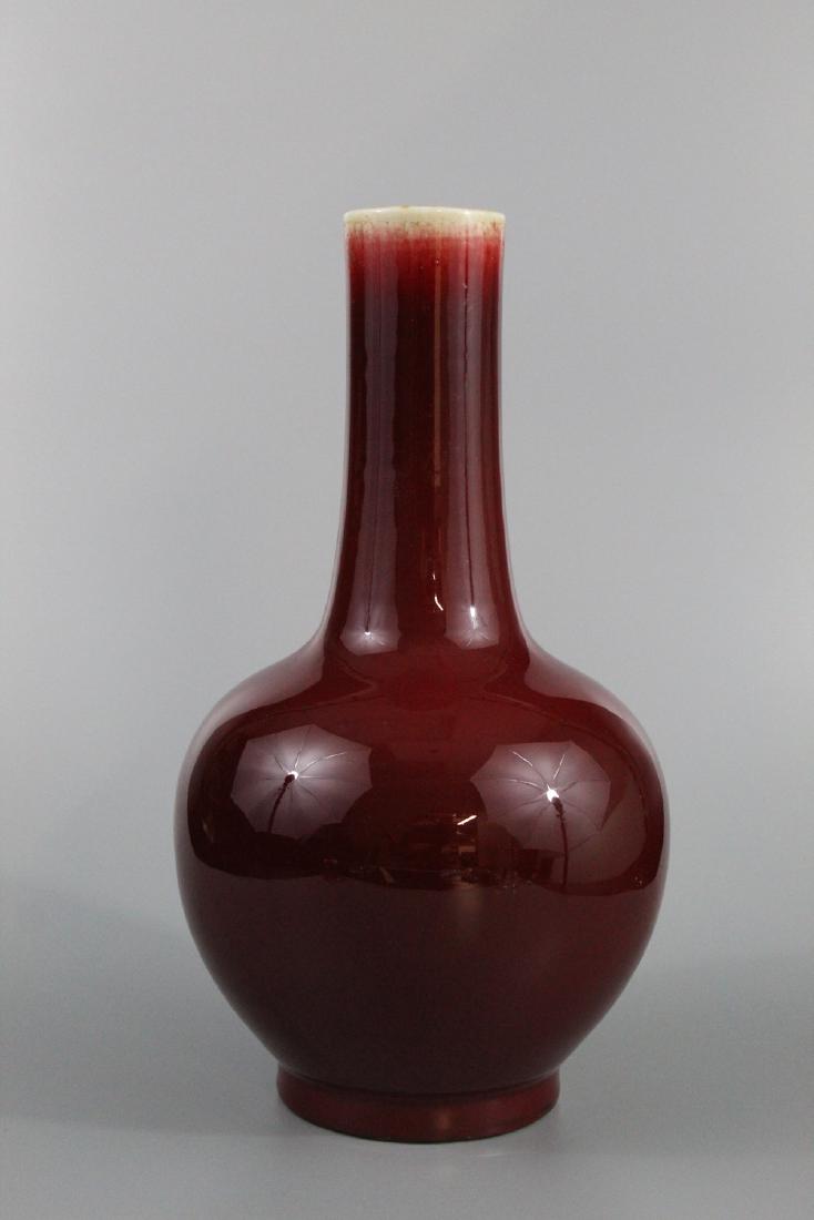 Chinese ox-blood red glaze porcelain vase.: Chinese ox-blood red glaze porcelain vase. Ht. 33 cm.