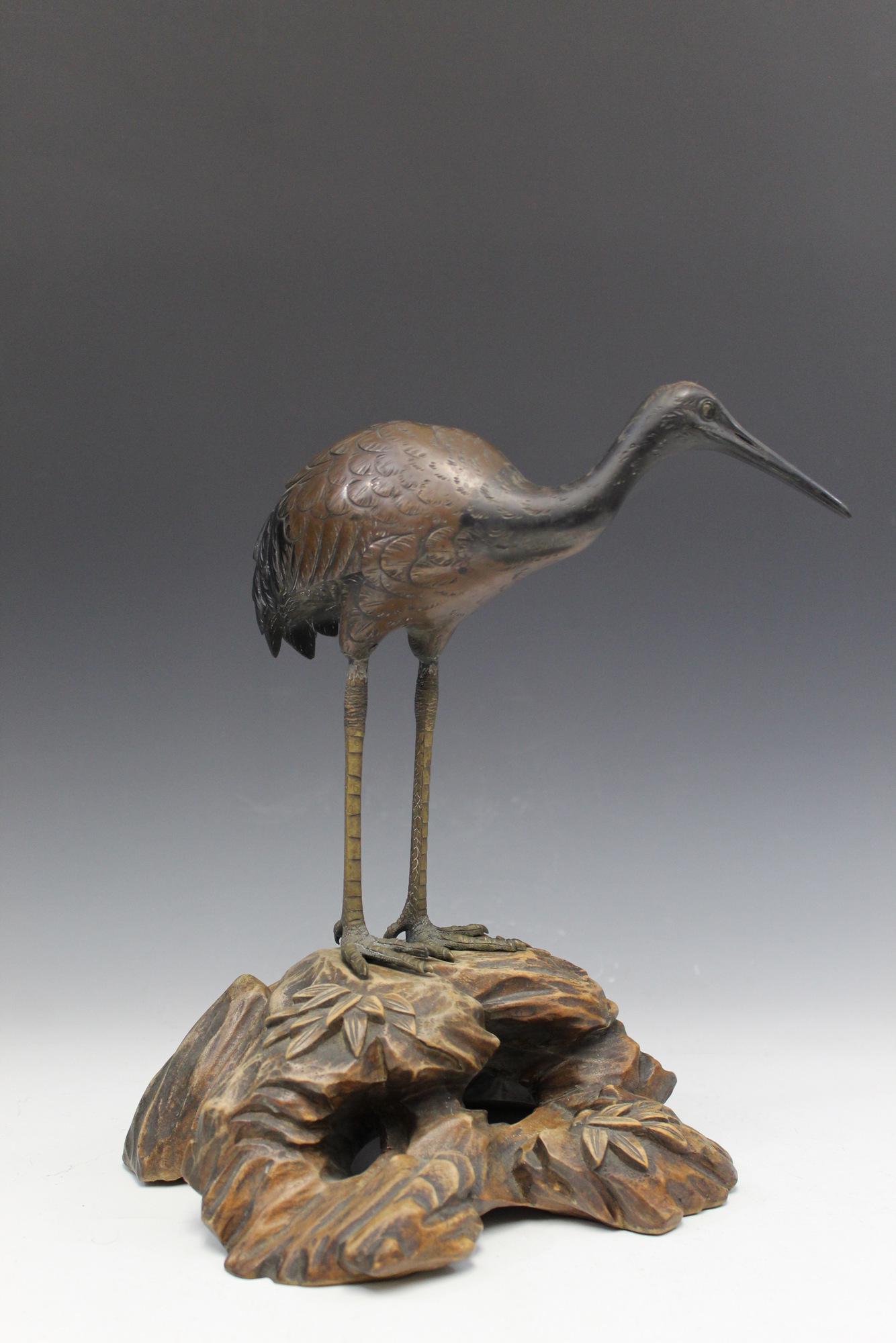 Japanese bronze figure of a crane on wood stand. (1 of 6)