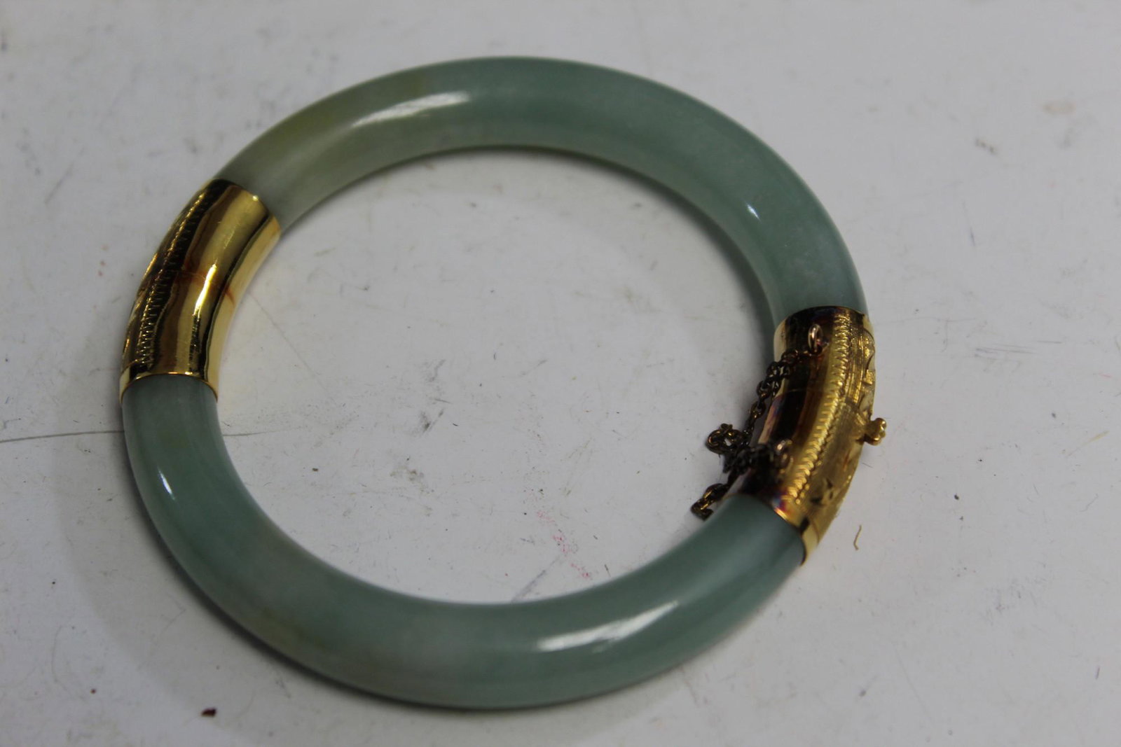 Chinese 14 K gold and jadeite bangle: Chinese 14 K gold and jadeite bangle. Inner rim diam 50 mm.