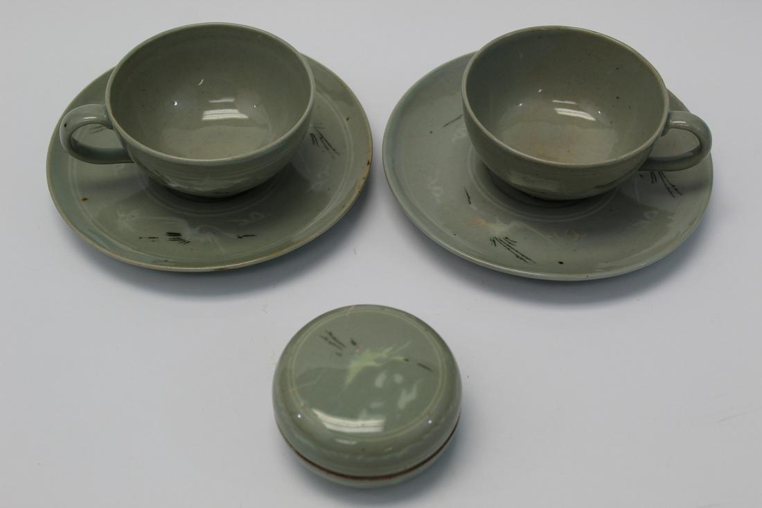 Pair of Korean Celadon Porcelain Cups and Saucers and A: Pair of Korean Celadon Porcelain Cups and Saucers and A Porcelain box. Saucers Diam 15 cm, Cup Diam 8.5 cm. Box Diam 7 cm.