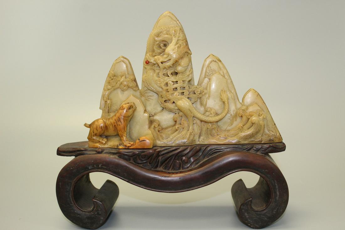Chinese carved soapstone brush holder on wood stand.: Chinese carved soapstone brush holder on wood stand. Total height 23 cm. Soapstone height 14 cm. Length 24 cm.