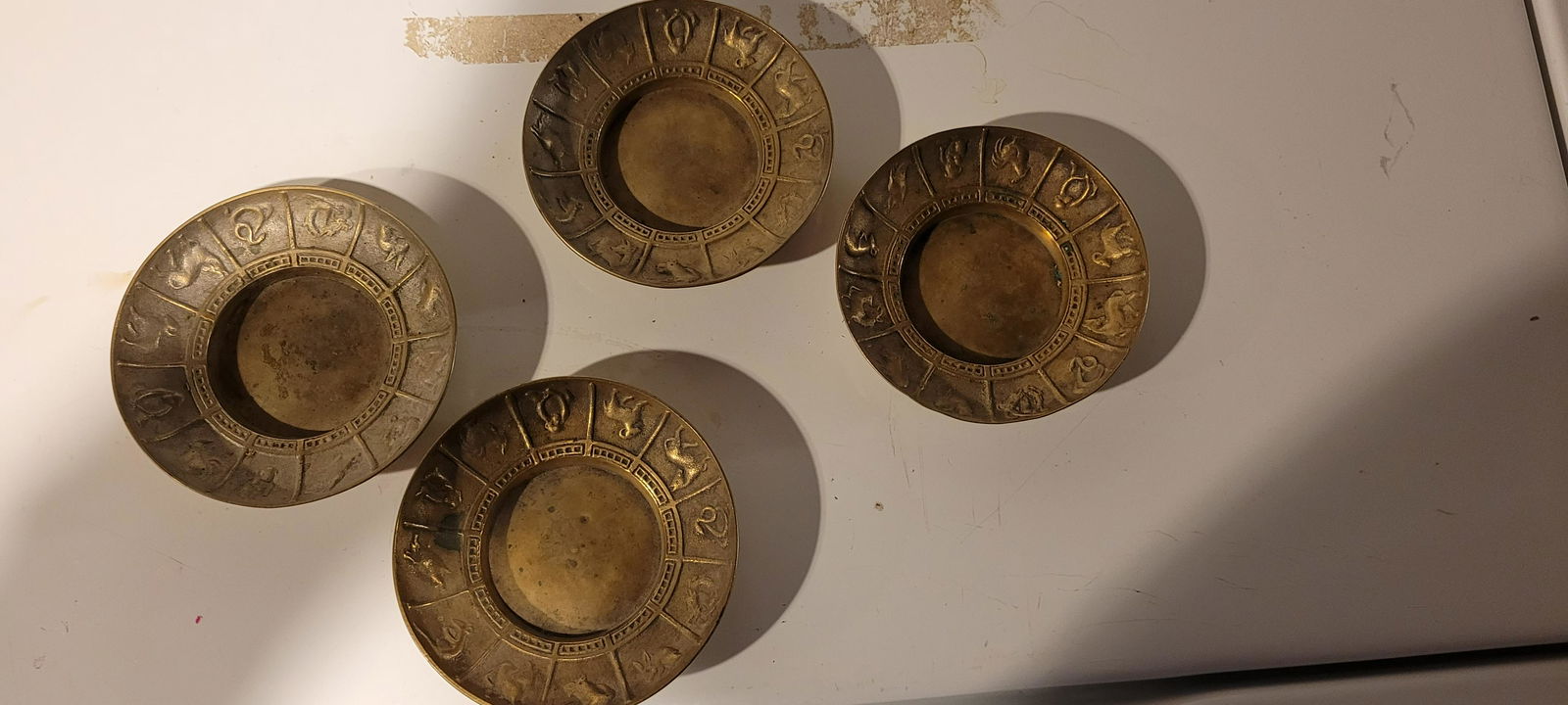 Four brass Zodiac trays Each apx. 5â€ diameter (1 of 1)