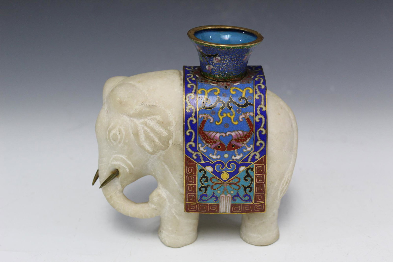 Chinese carved marble elephant with cloisonne saddle.: Chinese carved marble elephant with cloisonne saddle. Qing Dynasty. H 14 cm, L 14 cm.