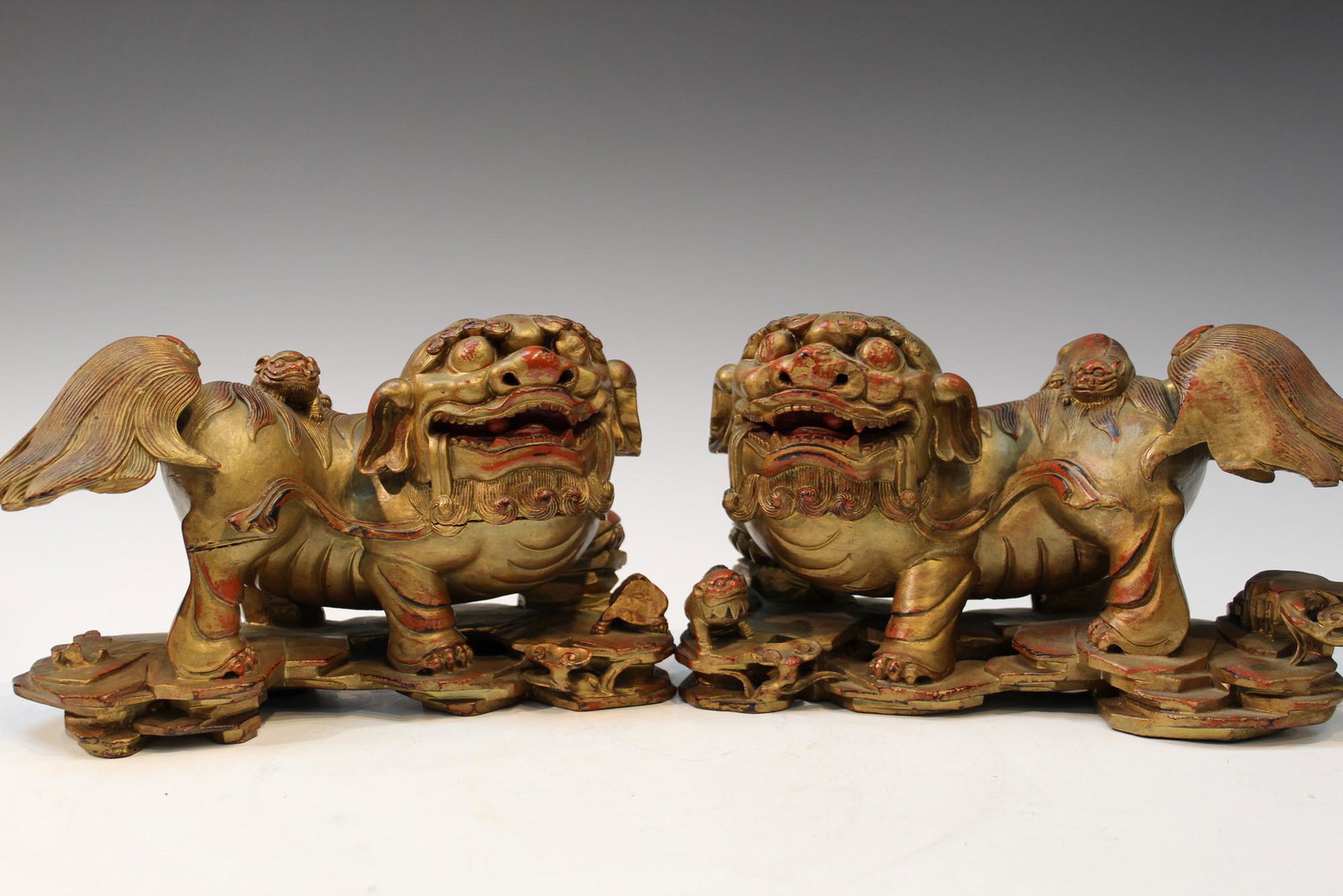 Pair of Chinese Wood Carved Foo Dogs: Pair of Chinese Wood Carved Foo Dogs. H 16cm x 27cm, D 11cm each