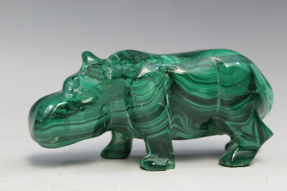Carved malachite figure of a rhinoceros.: Carved malachite figure of a rhinoceros. Length 11.5 cm.