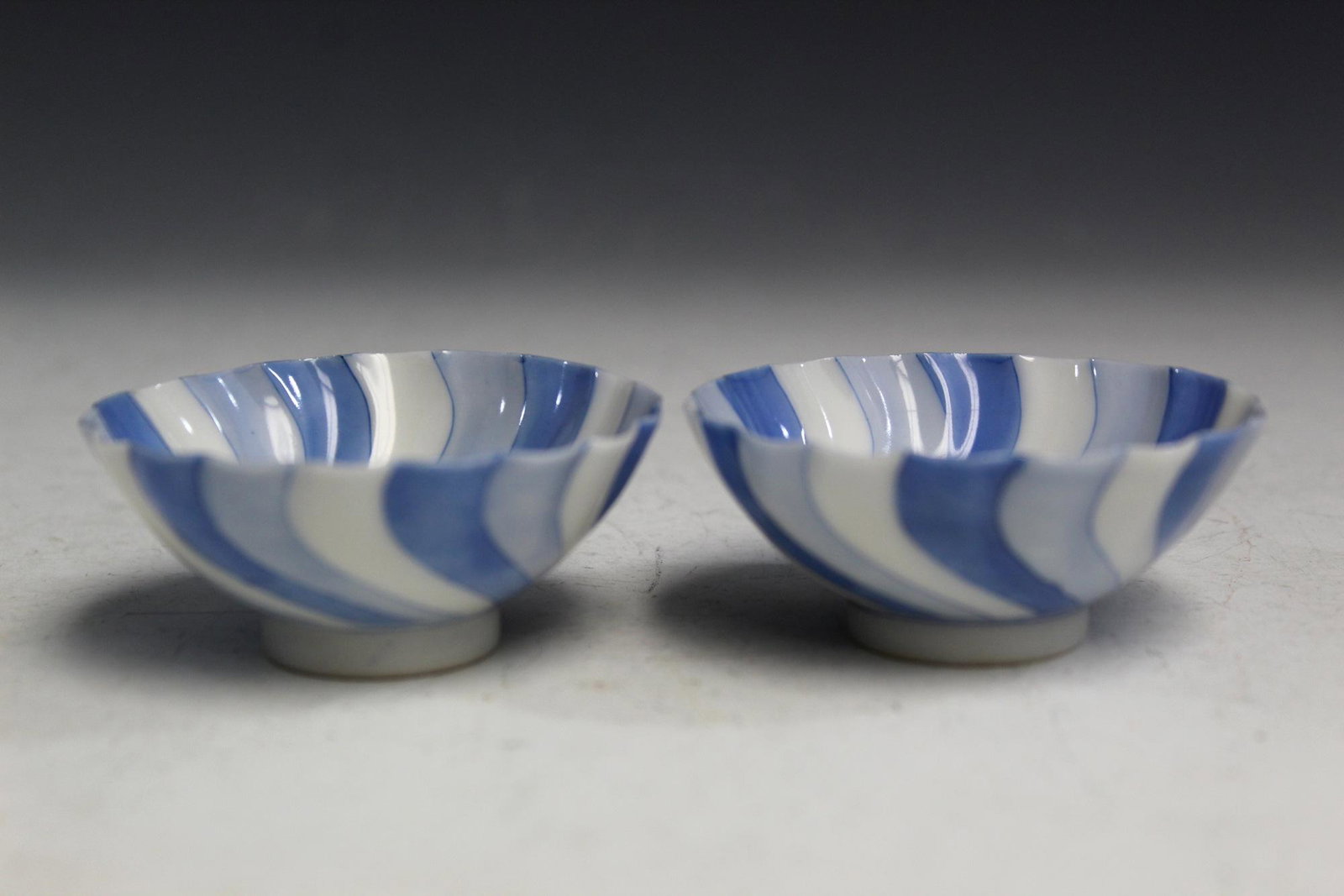 A Pair of Japanese Blue and White Porcelain Cups.: A Pair of Japanese Blue and White Porcelain Cups. Diam 7 cm.