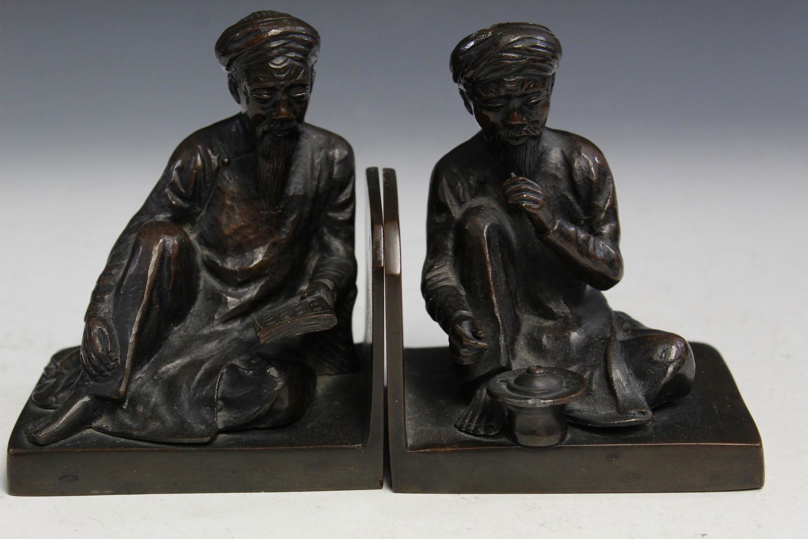 Two Bronze Bookends: Two Bronze Bookends. H 13 cm.