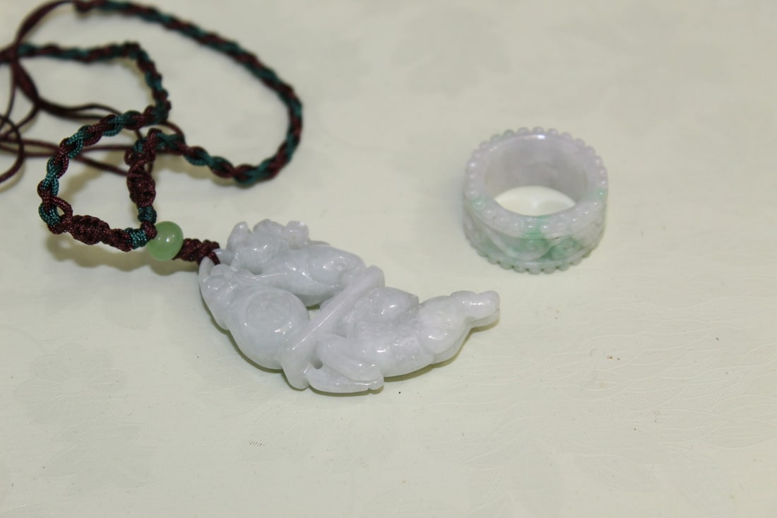 Chinese Carved Jadeite Pendant Necklace and a Ring: Chinese Carved Jadeite Pendant Necklace and a Ring. Pendant L 5 cm. Rim size 7.5