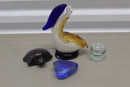 Group of four glass paper weights