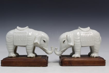 Pair of Chinese Blanc de Chine Porcelain Elephant Figures on Wood Stands.