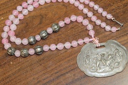 Beaded necklace with silver pendant