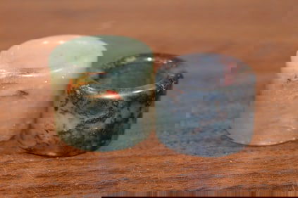 Two Chinese carved jade thumb rings