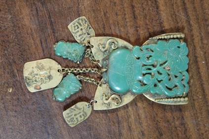 Carved green stone brooch.