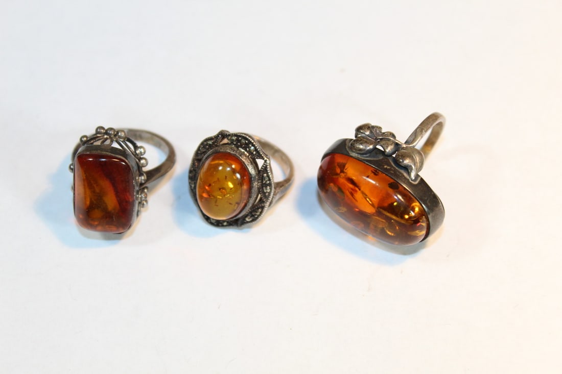 Three Amber and Silver rings: Three Amber and Silver rings. Largest cabochon length 2.5 cm.