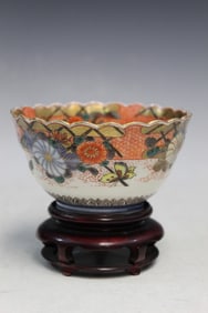 Japanese porcelain bowl on wood stand