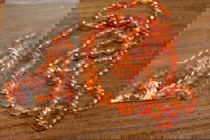 A Bag of Amber Beads and An Amber Beads Necklace.