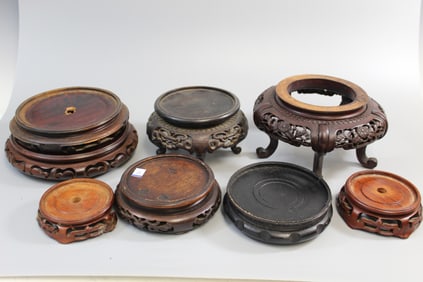Group of eight carved wood stands