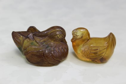 Two Chinese Carved Amber Toggles