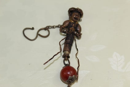 Chinese Metal Needle Holder Pendant with a Red Agate Bead.