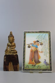 An Indian painted stone plaque and a carved wood buddha statue