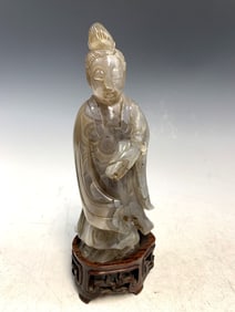 Chinese carved agate figure of a lady on wood stand.