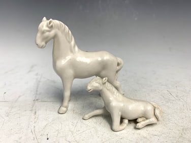 Two Chinese blanc de chine porcelain horses.