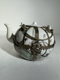Chinese porcelain teapot with Tibetan silver outer casing