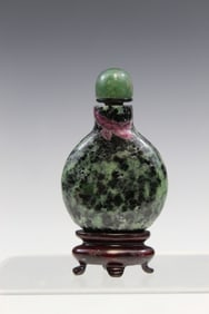 Chinese green stone snuff bottle. Stand was glued on the bottle.