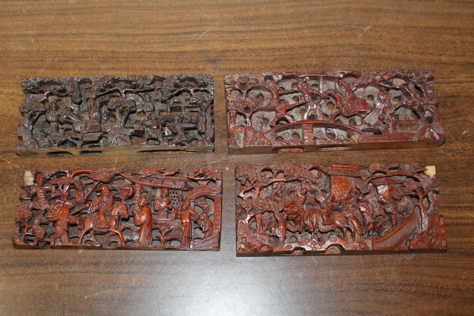 Four Chinese carved wood panels: Four Chinese carved wood panels. 6.5" x 2.75" each