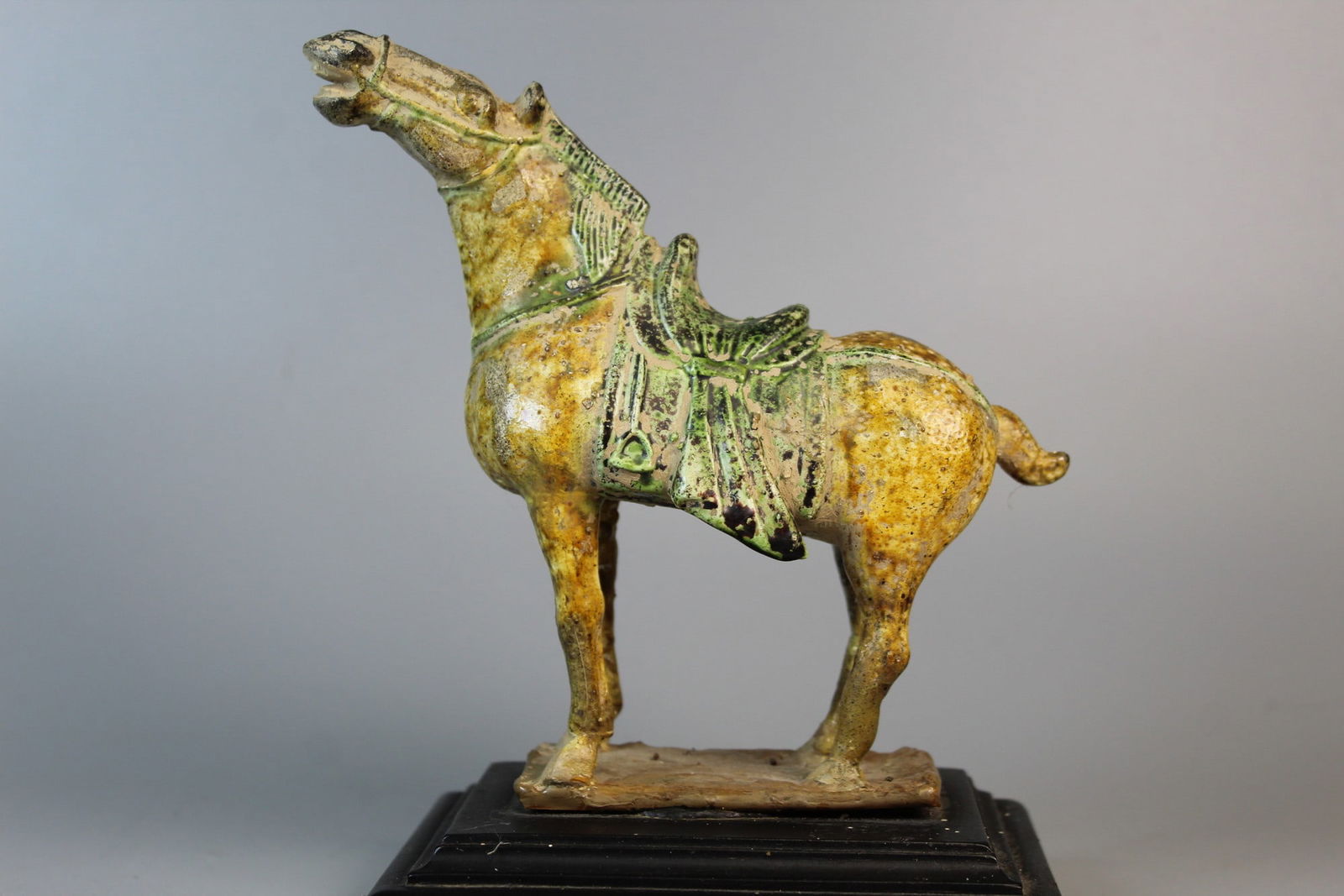 Chinese Sancai Pottery Horse Figure on Wood Stand.: Chinese Sancai Pottery Horse Figure on Wood Stand. . H 6.5". L 7".