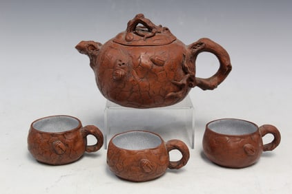 Chinese Yixing teapot and three tea cups.
