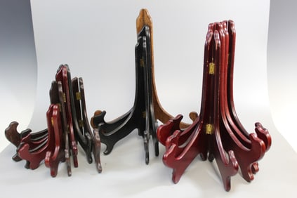 A dozen wood plate stands