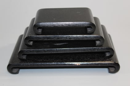 Set of four wood scroll shaped stands